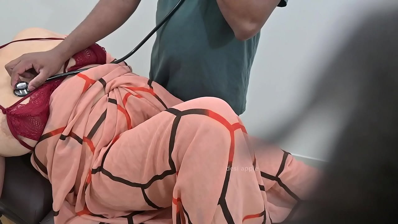 Indian doctor checking lady patient in clinic